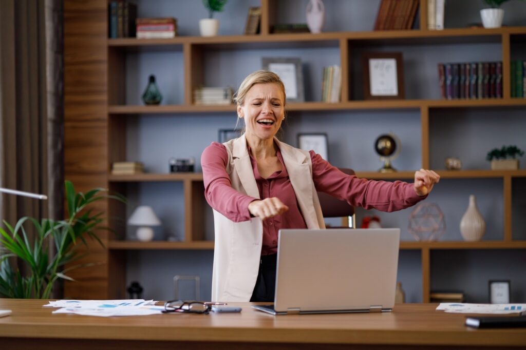 Female trader dancing at workplace. Happy businesswoman got positive news. Victory dance, fast