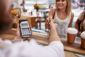 customer paying at a cafe with credit card 300x200 - Preparing Your Business for Events Like Banking System Outages