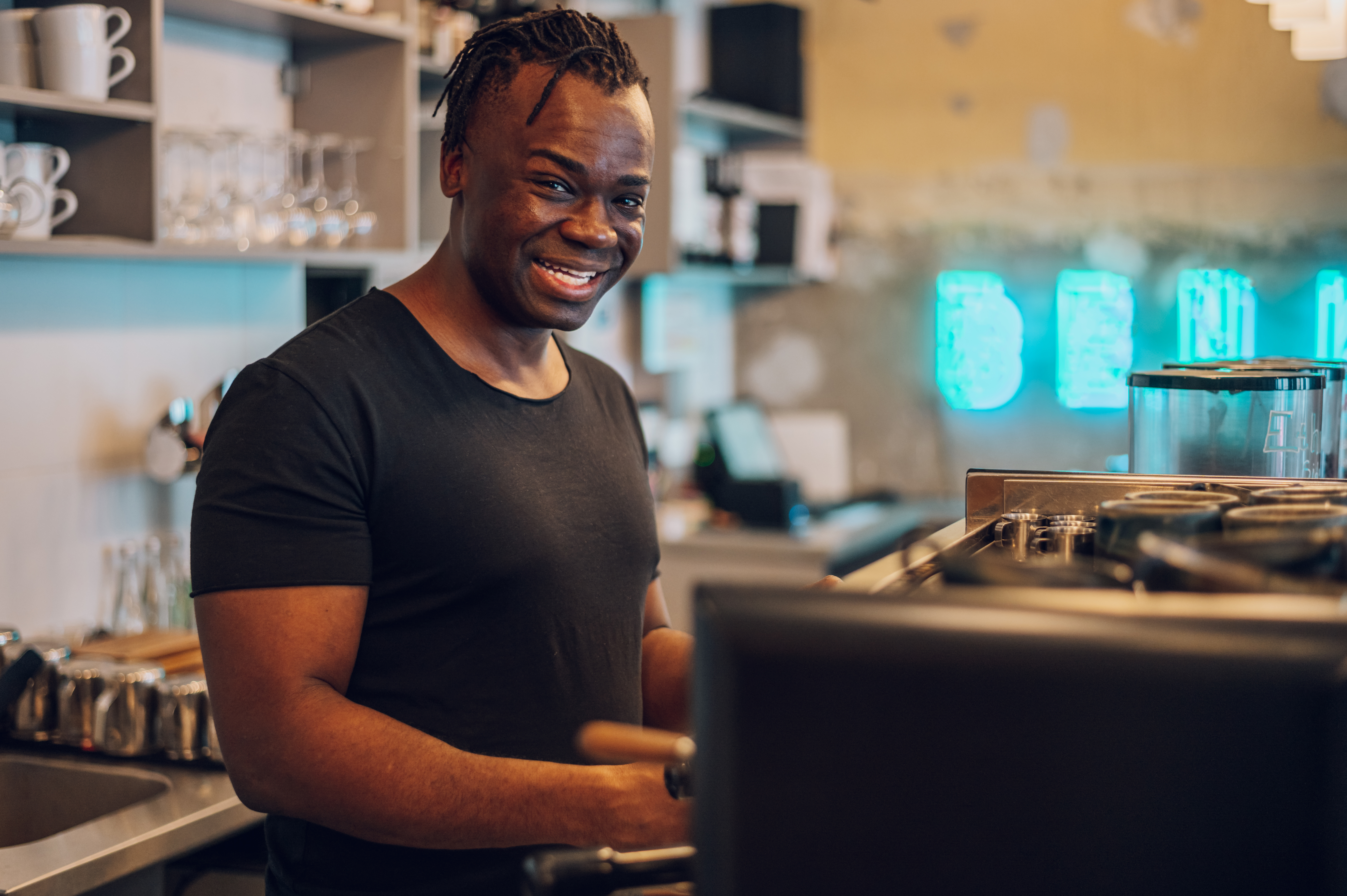 portrait of an african american male coffee shop owner barista working in a care  - Blog