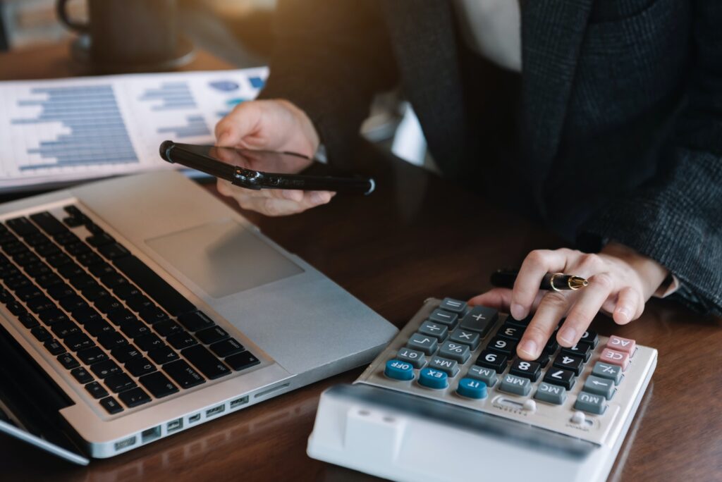 Analysts discuss business with a calculator as a tool.