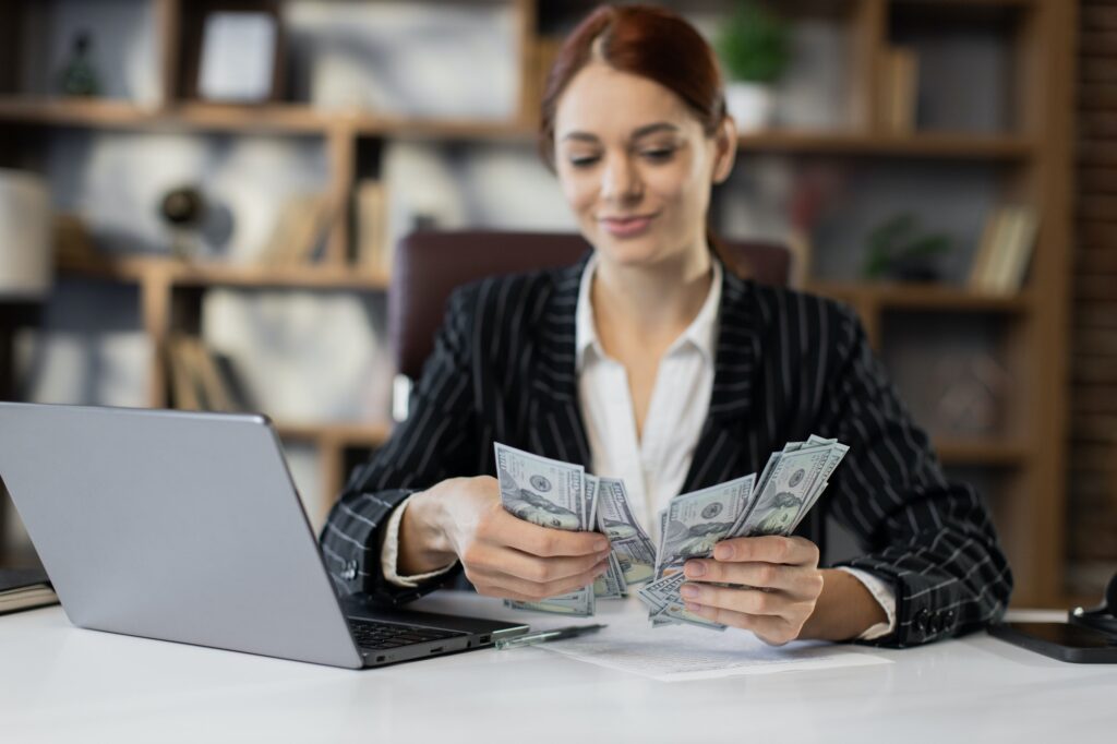 Woman counting money. Business investment.