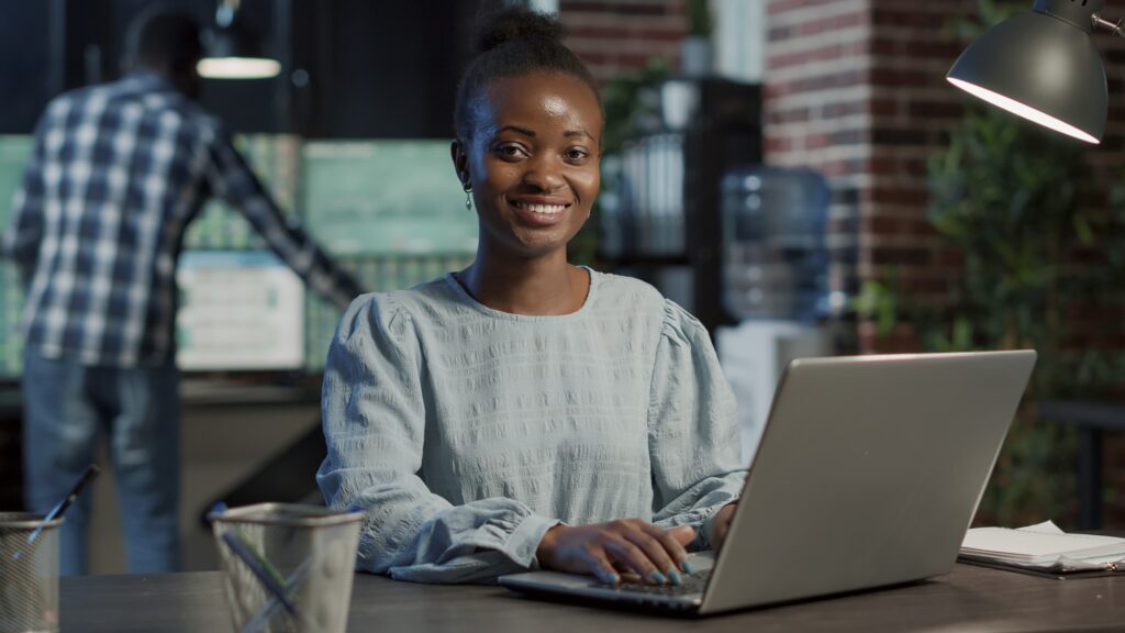 Portrait of sales assistant working on laptop to create capital profit