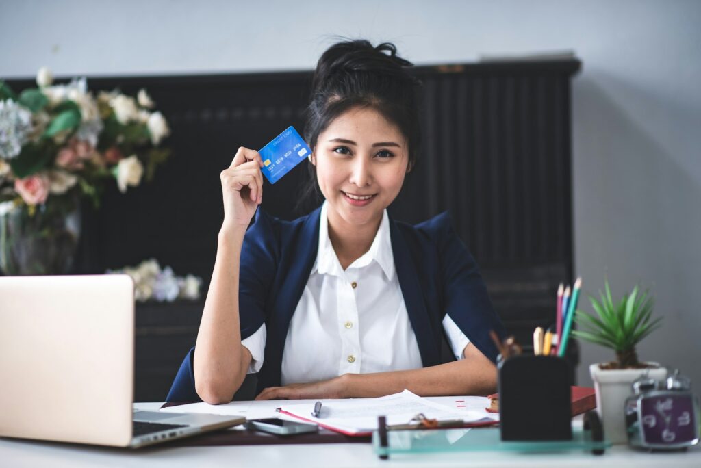 A young businessman is working with a credit card transaction.