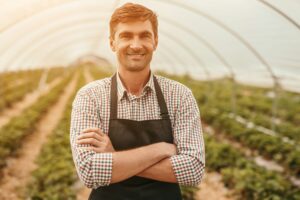 Confident small business owner in greenhouse