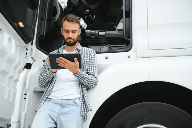 Men driver near lorry truck. Man owner truck driver near truck. Man trucker trucking owner.